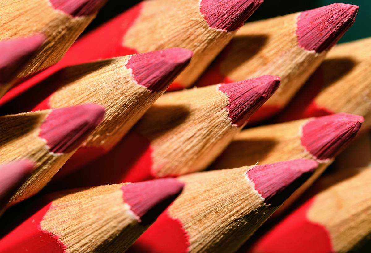 Close-up of hand using a sharp lip marker to define lips with clean, crisp lines