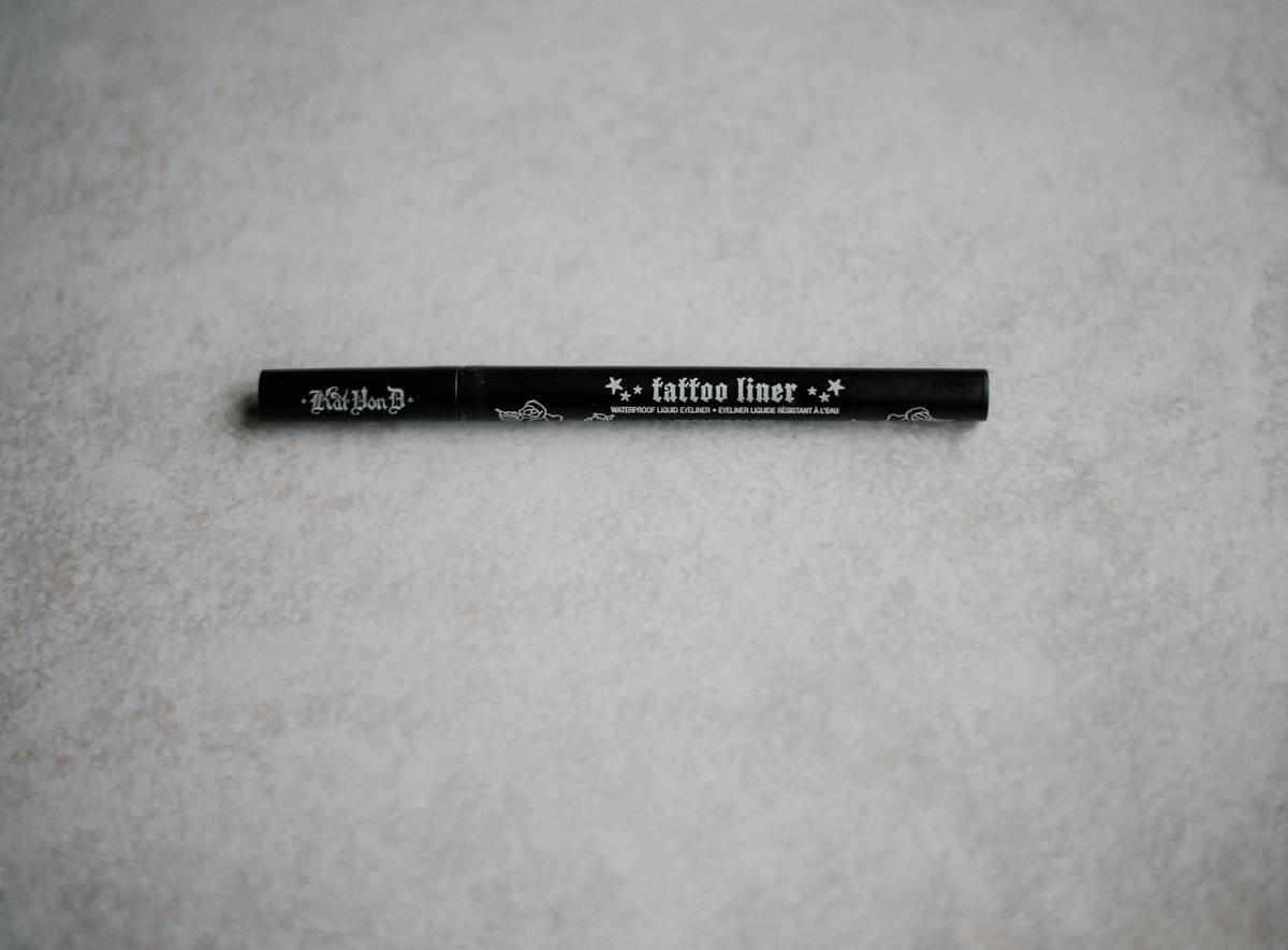 Close-up of model applying lip shaping shade with pencil along natural lip line