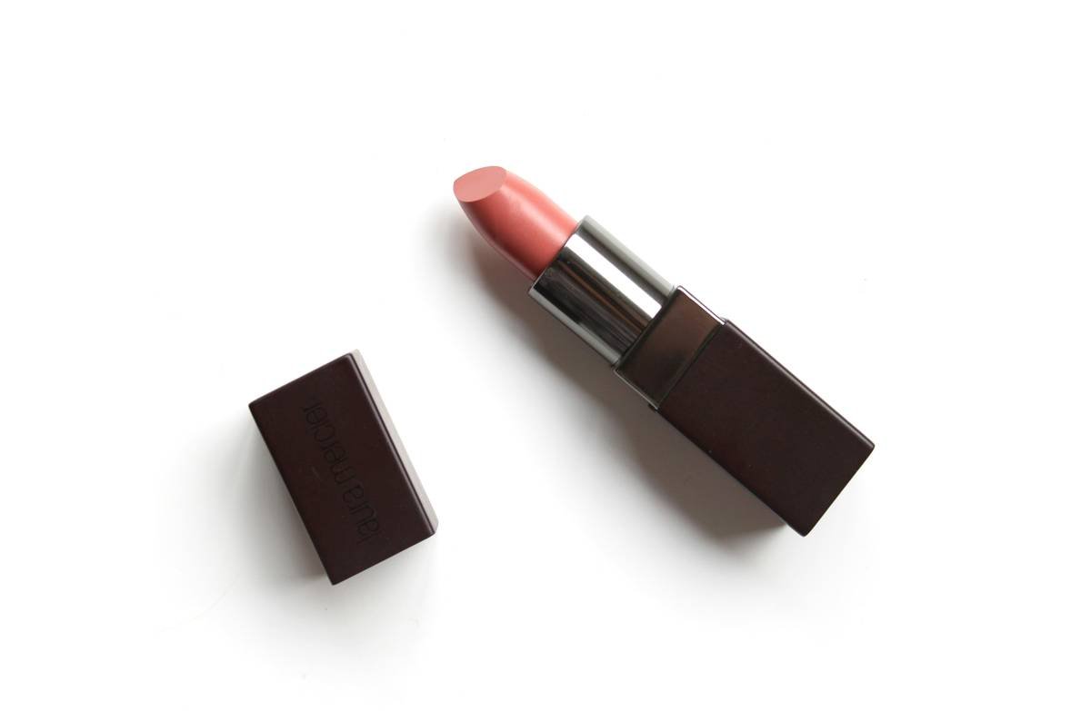 Model applying fade-resistant lip color with lip pencil for all-day wear