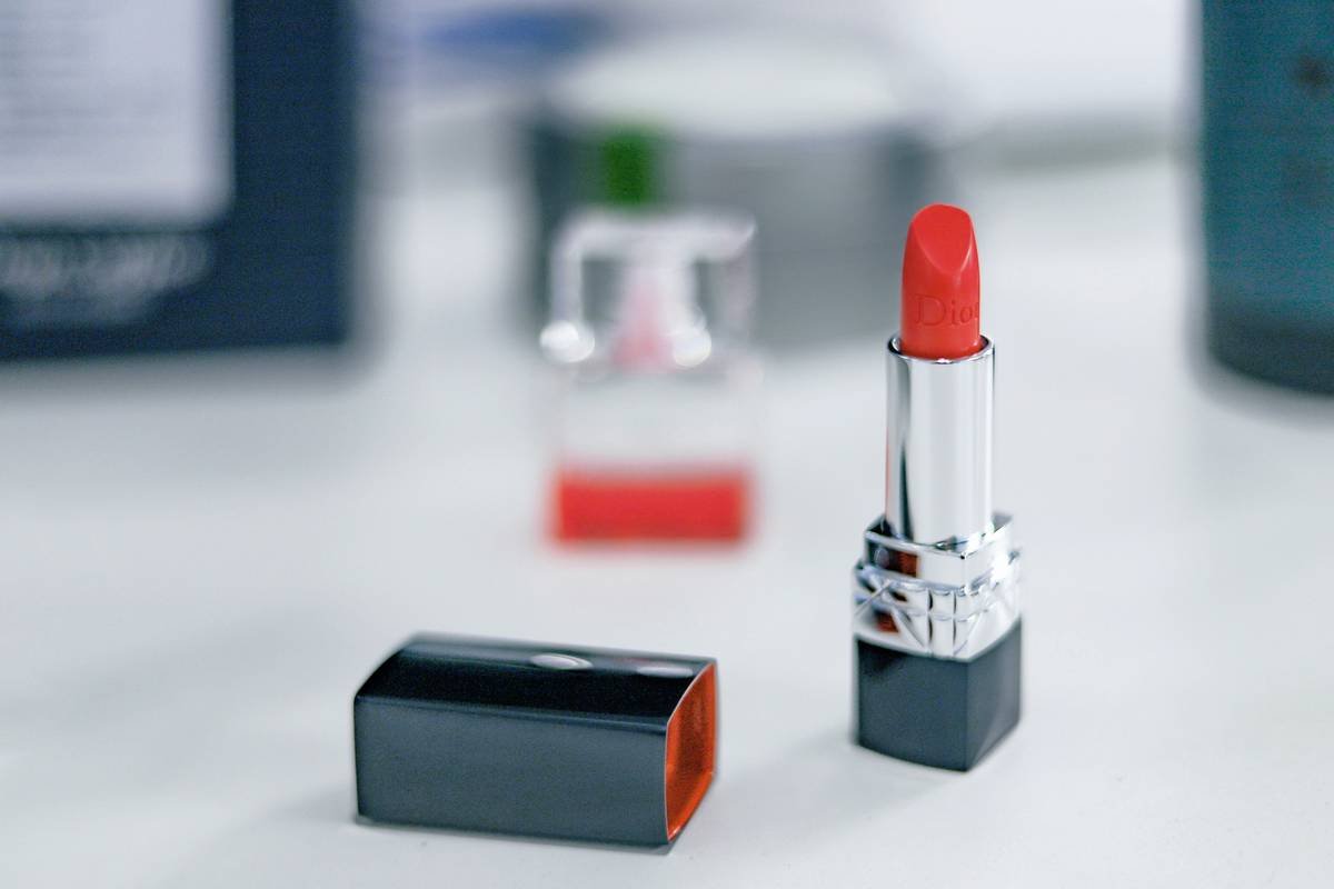 Woman applying lasting lip hue with precision using a sharpened lip pencil